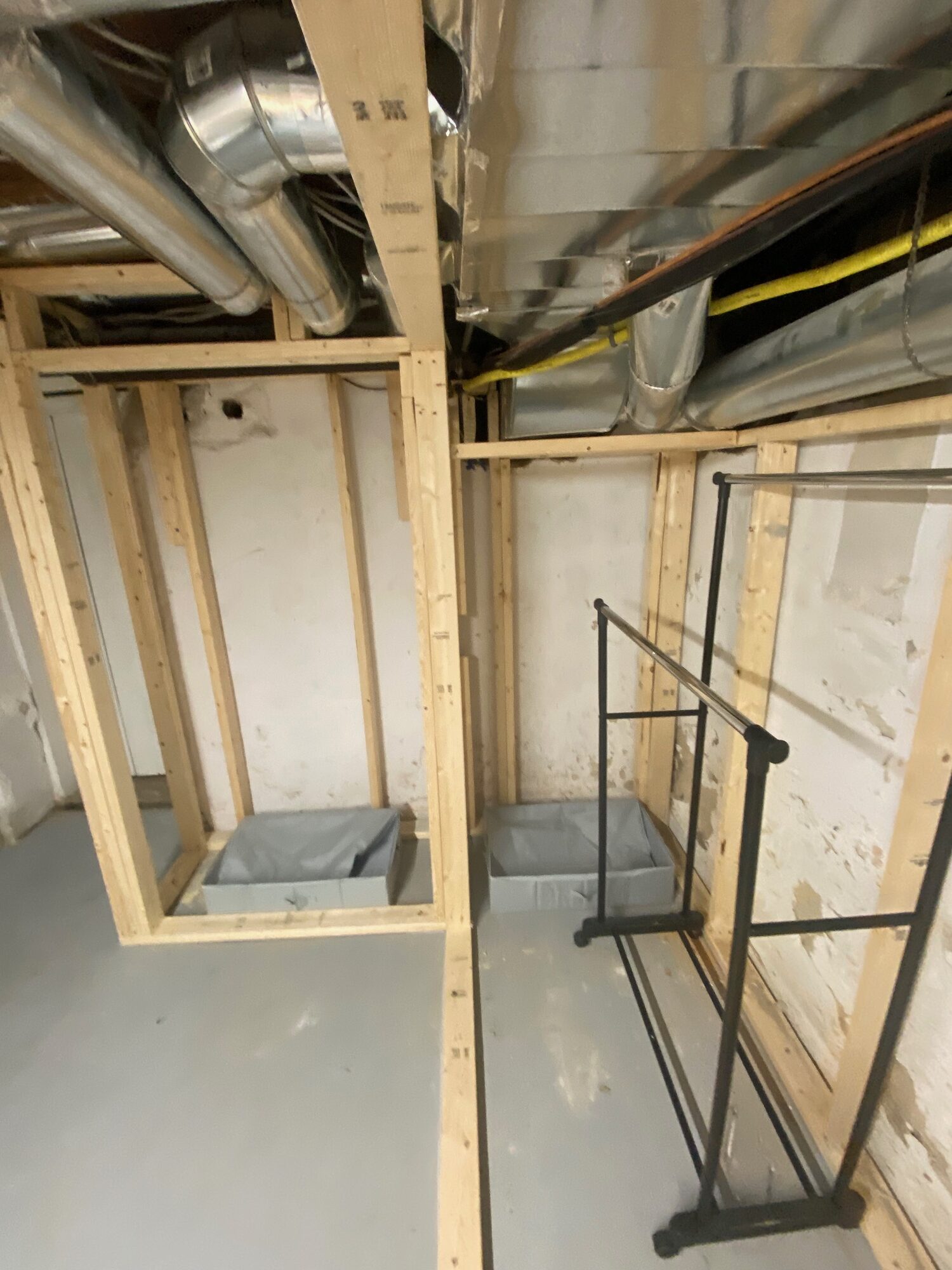 Basement stud walls framed in around the ductwork and the utility area.